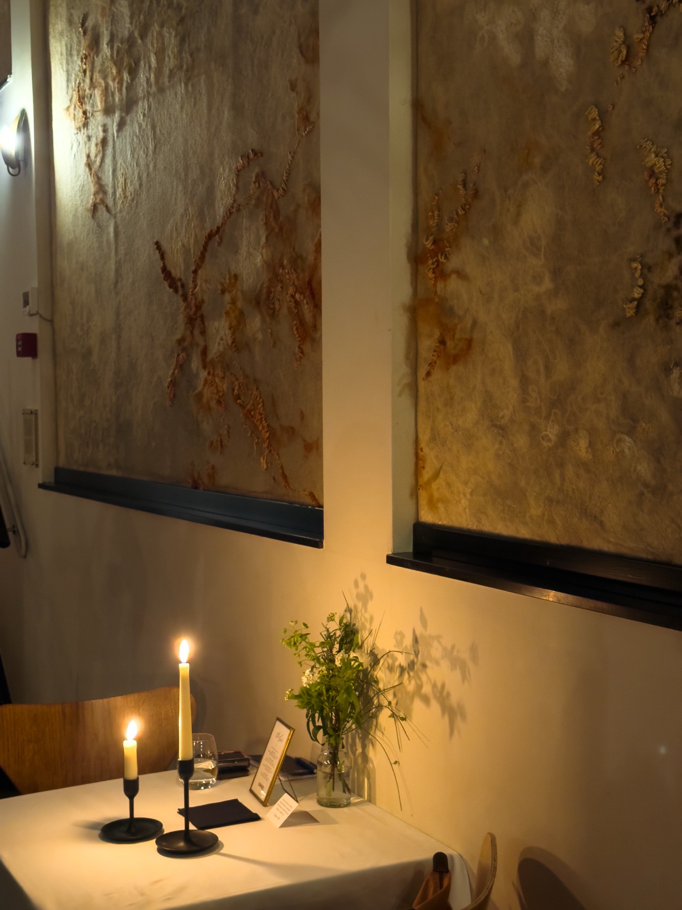 Candlelight against the wall during Velvet Hours for Eurazeo