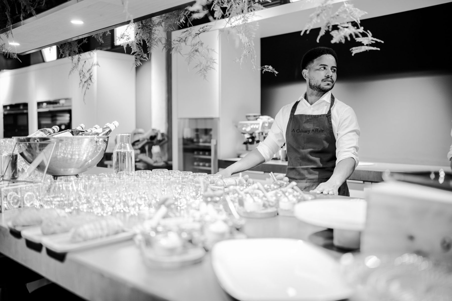 Chef preparing appetizers at the kitchen counter of KITCHEN 55
